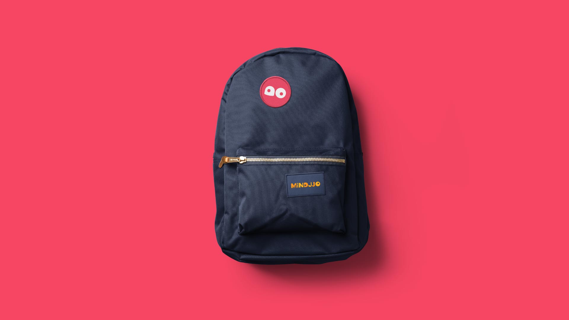 Mindjjo branded badge designs sewn on a backpack.